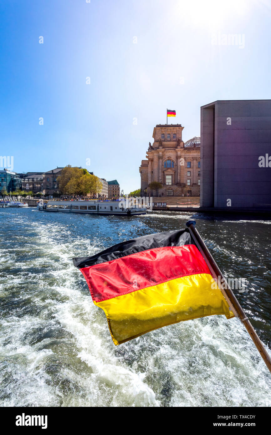 Germany, Berlin, Reichstag and German flag on excursion boat on River Spree Stock Photo