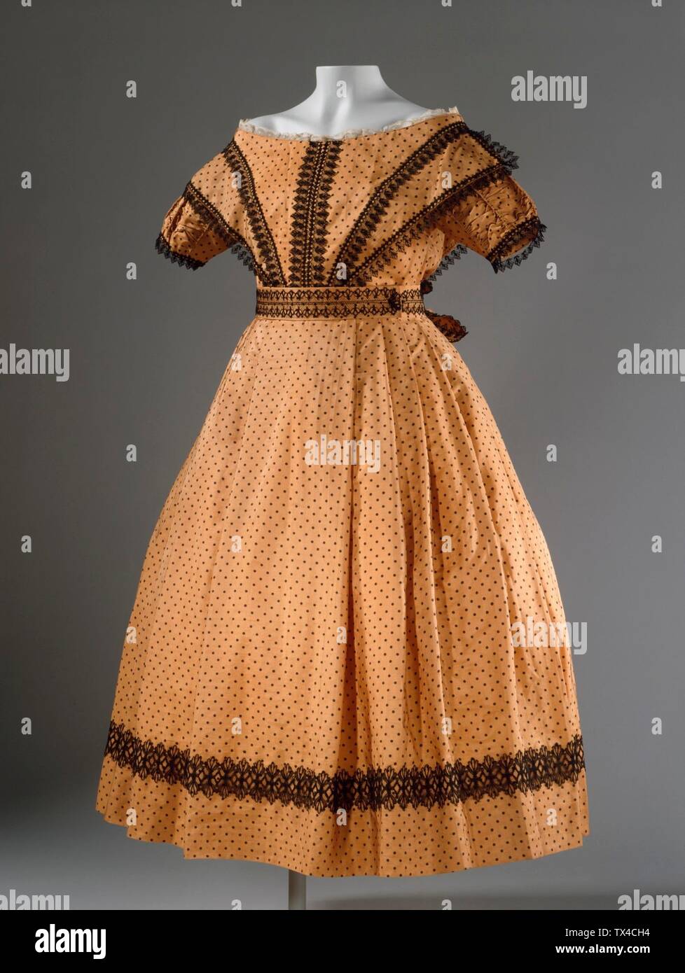 Girl's Dress with Pelerine (image 1 of 2); England, circa 1869 Costumes; ensembles Silk .1) Dress center back length: 36 in. (91.44 cm); .2) Pelerine center back length: 14 in. (35.56 cm); .3) Sash length: 25 in. (63.5 cm); .4-.5) Sleeve length: 15 in. (38.1 cm) each Gift of Helen Larson (AC1997.191.3.1-.5) Costume and Textiles; circa 1869 date QS:P571,+1869-00-00T00:00:00Z/9,P1480,Q5727902; Stock Photo