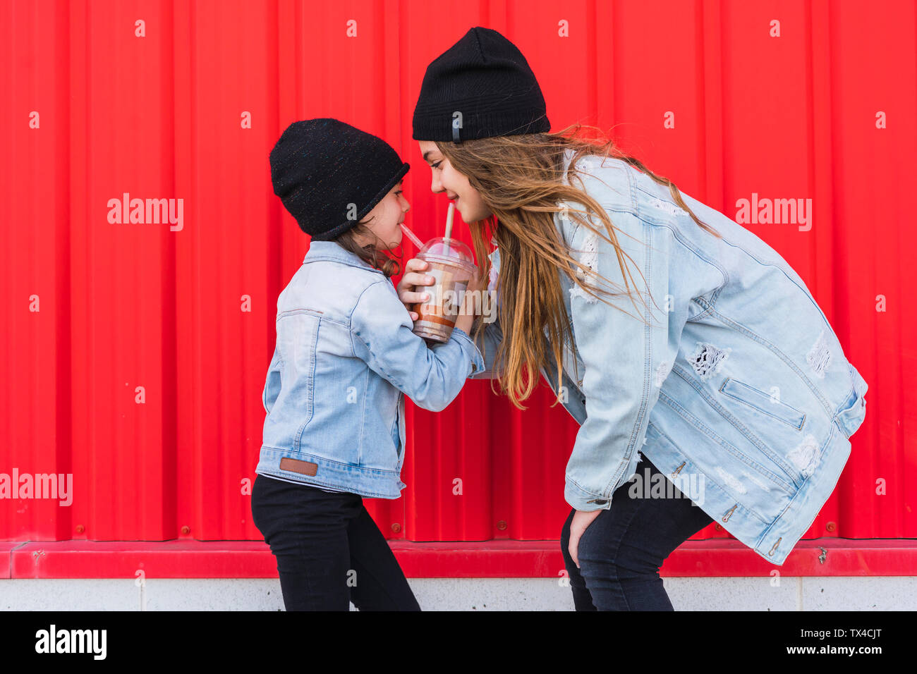 Teenage girl and little sister having fun together Stock Photo