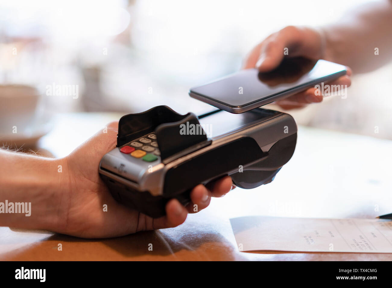 Contactless payment with smartphone, close-up Stock Photo