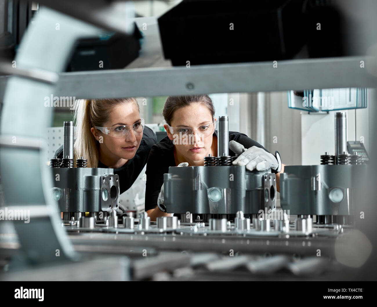 Young women checking production line on a conveyor belt Stock Photo - Alamy