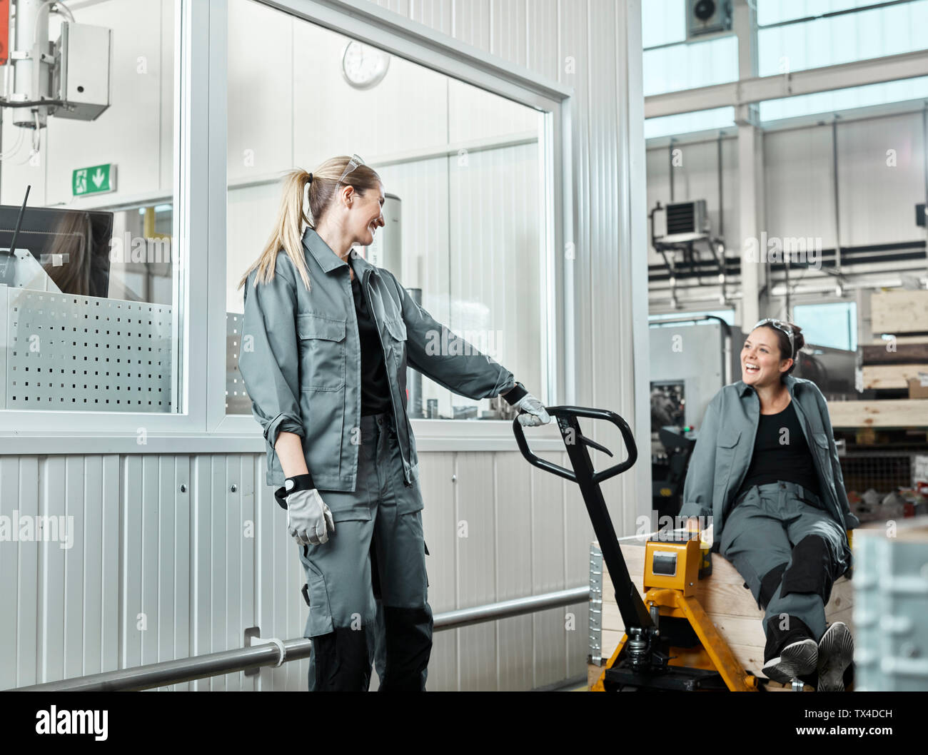 Industry, women using pallet jack Stock Photo Alamy