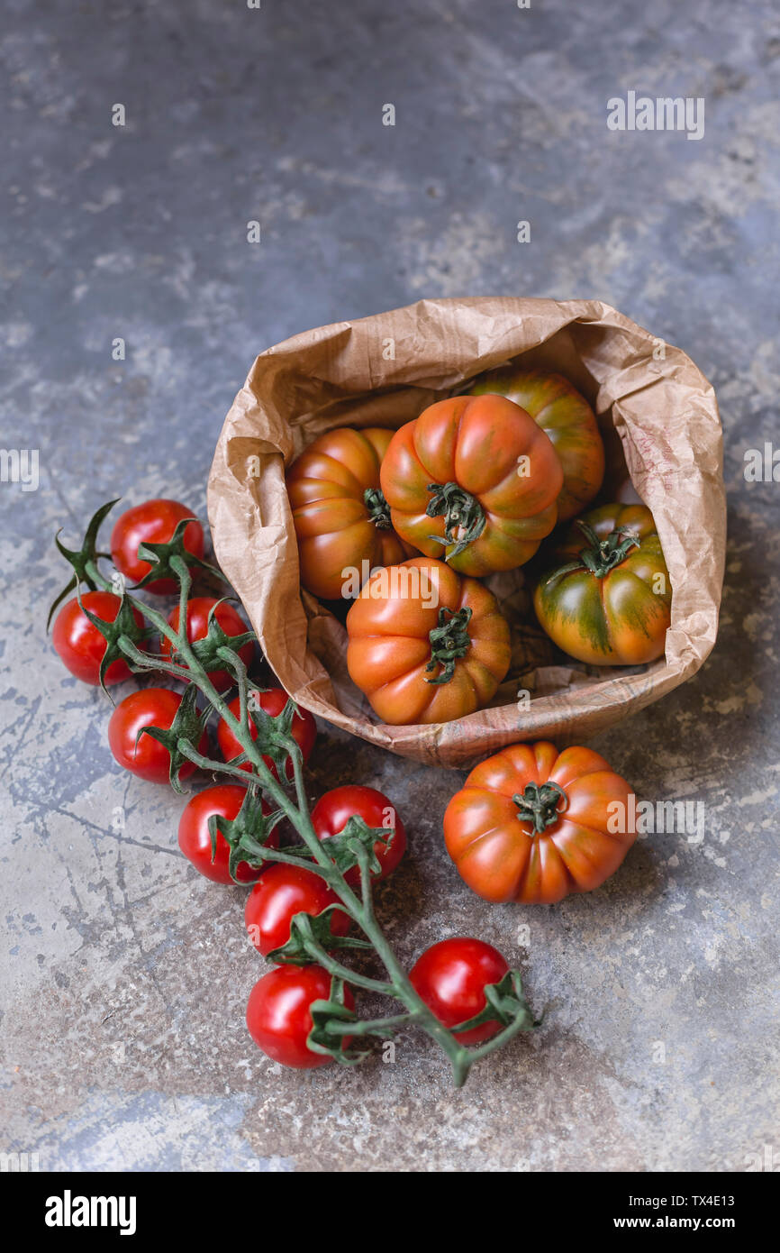 Sardinian beef tomatoes in paper bag and risp of mini plum tomatoes Stock Photo