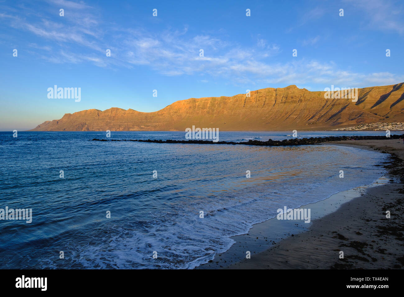 Spain, Canary Islands, Lanzarote, Caleta de Famara, Risco de Famara in the evening light Stock Photo