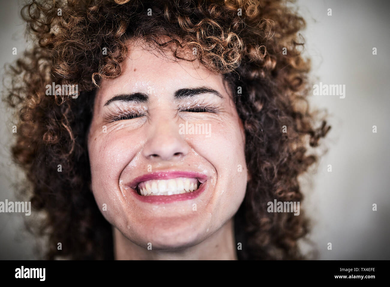 Portrait of sweating woman with curly hair Stock Photo - Alamy