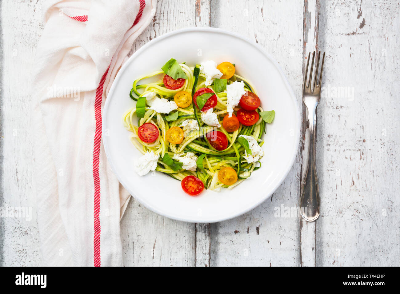 Zoodles salad with tomatoes, Buffalo Mozzarella and basil Stock Photo
