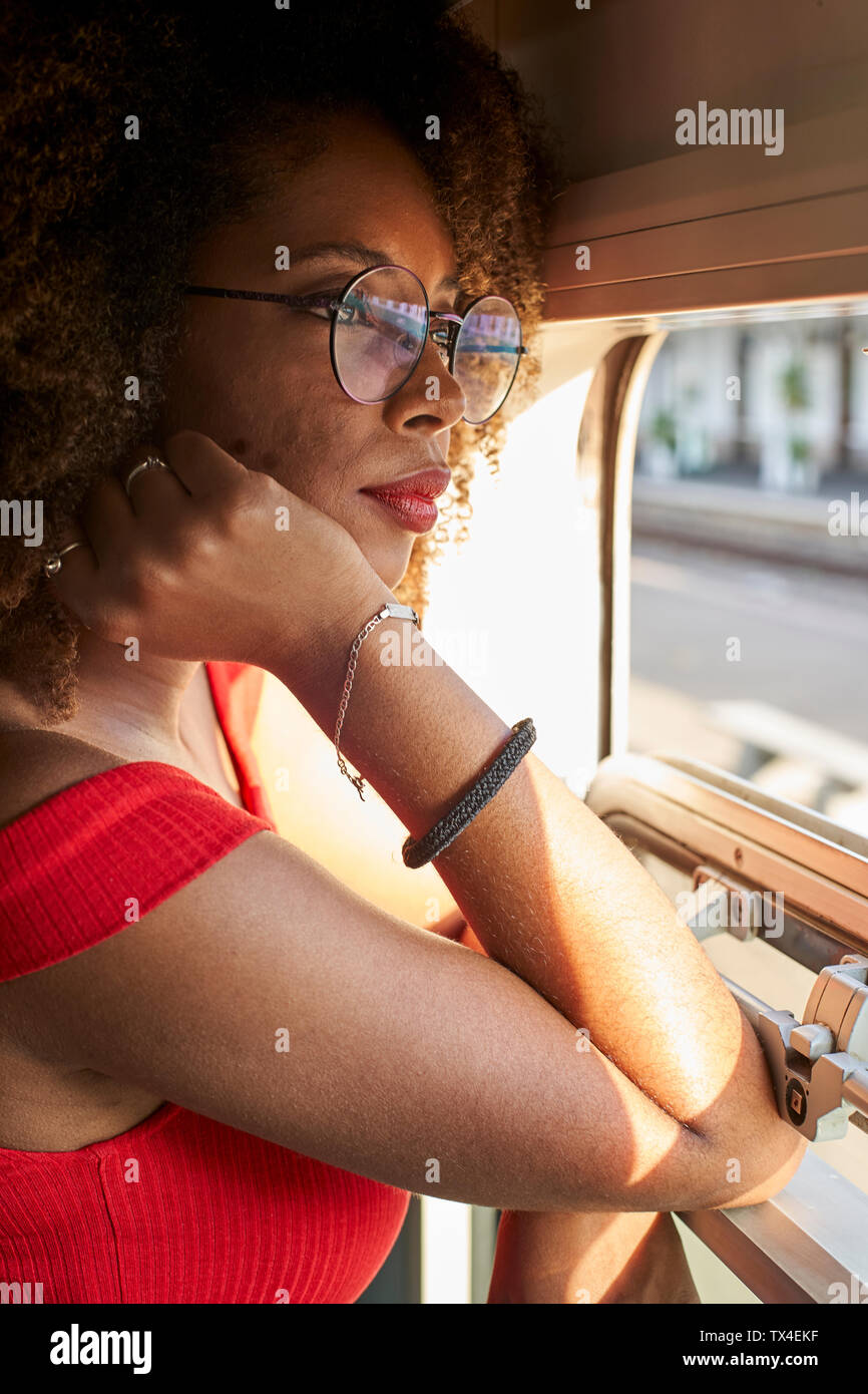 Young woman on a train looking out of window Stock Photo