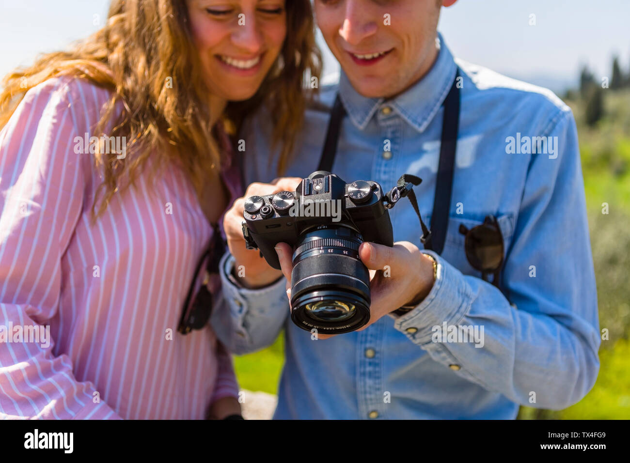Couple looking at pictures on their digital camera Stock Photo