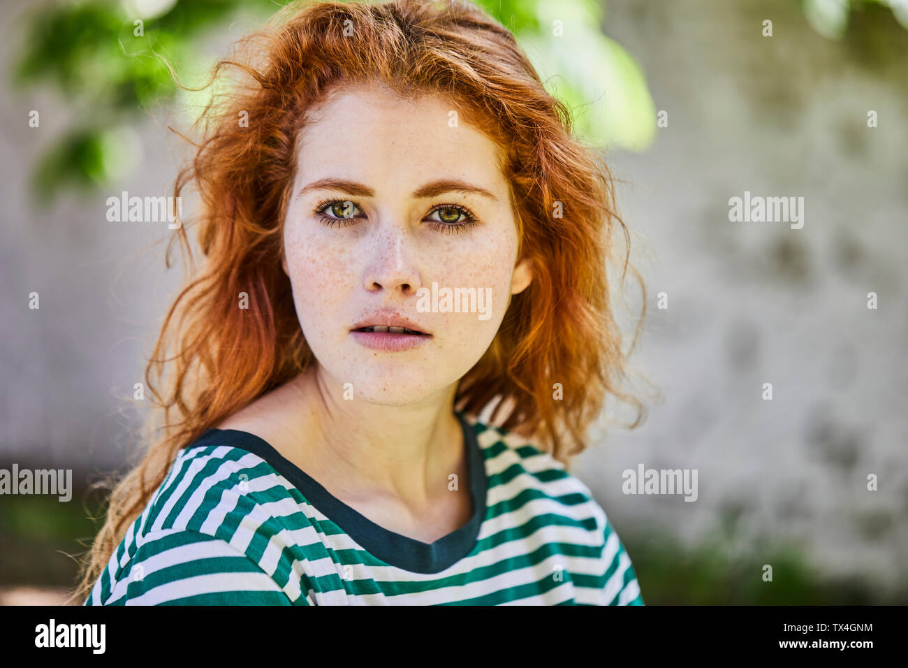 Portrait of redheaded young woman with freckles Stock Photo