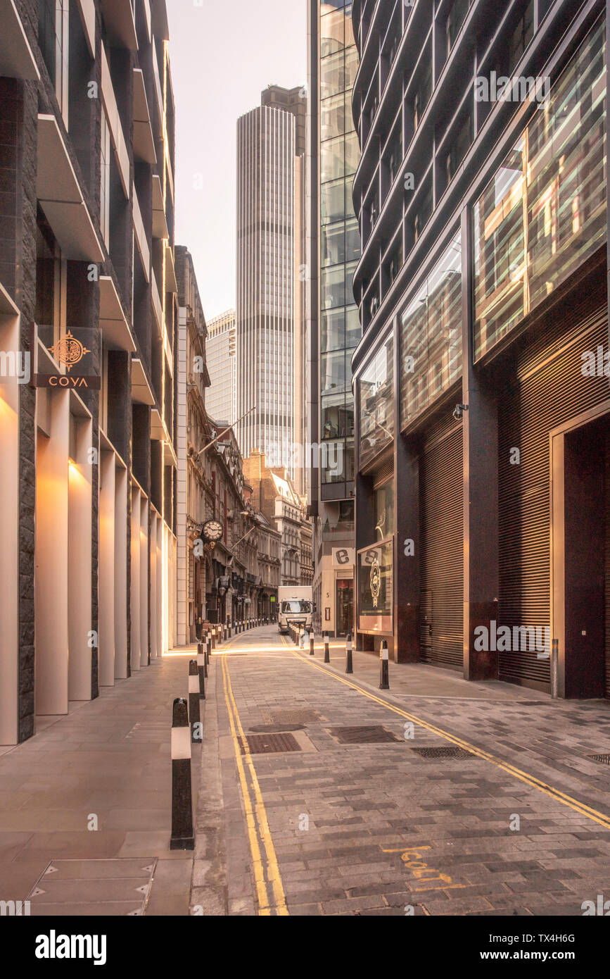 UK, London, narrow street in the City of London financial district with skyscrapers in the background Stock Photo