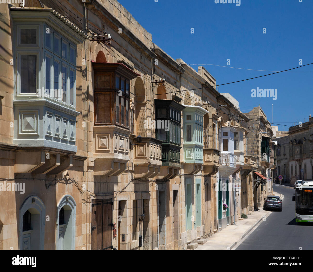 typical-first-floor-balcony-windows-on-a-street-in-malta-stock-photo