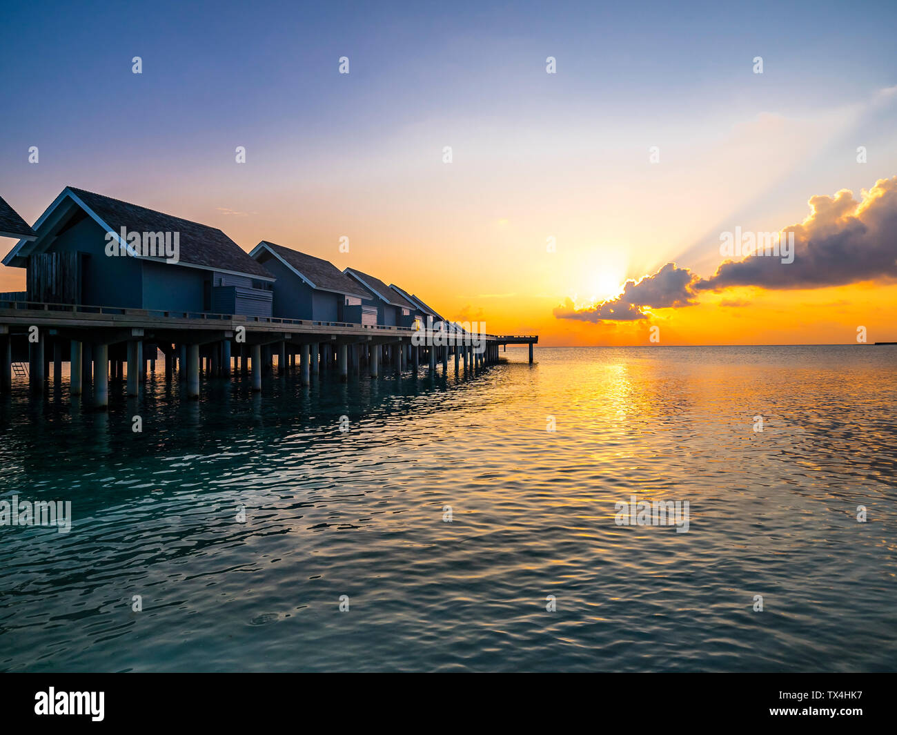 Maledives, Ross Atoll, water bungalows at sunset Stock Photo