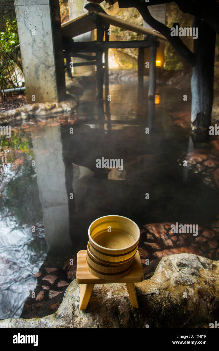 Japan, Kyushu, bowls on stool at hot springs Stock Photo