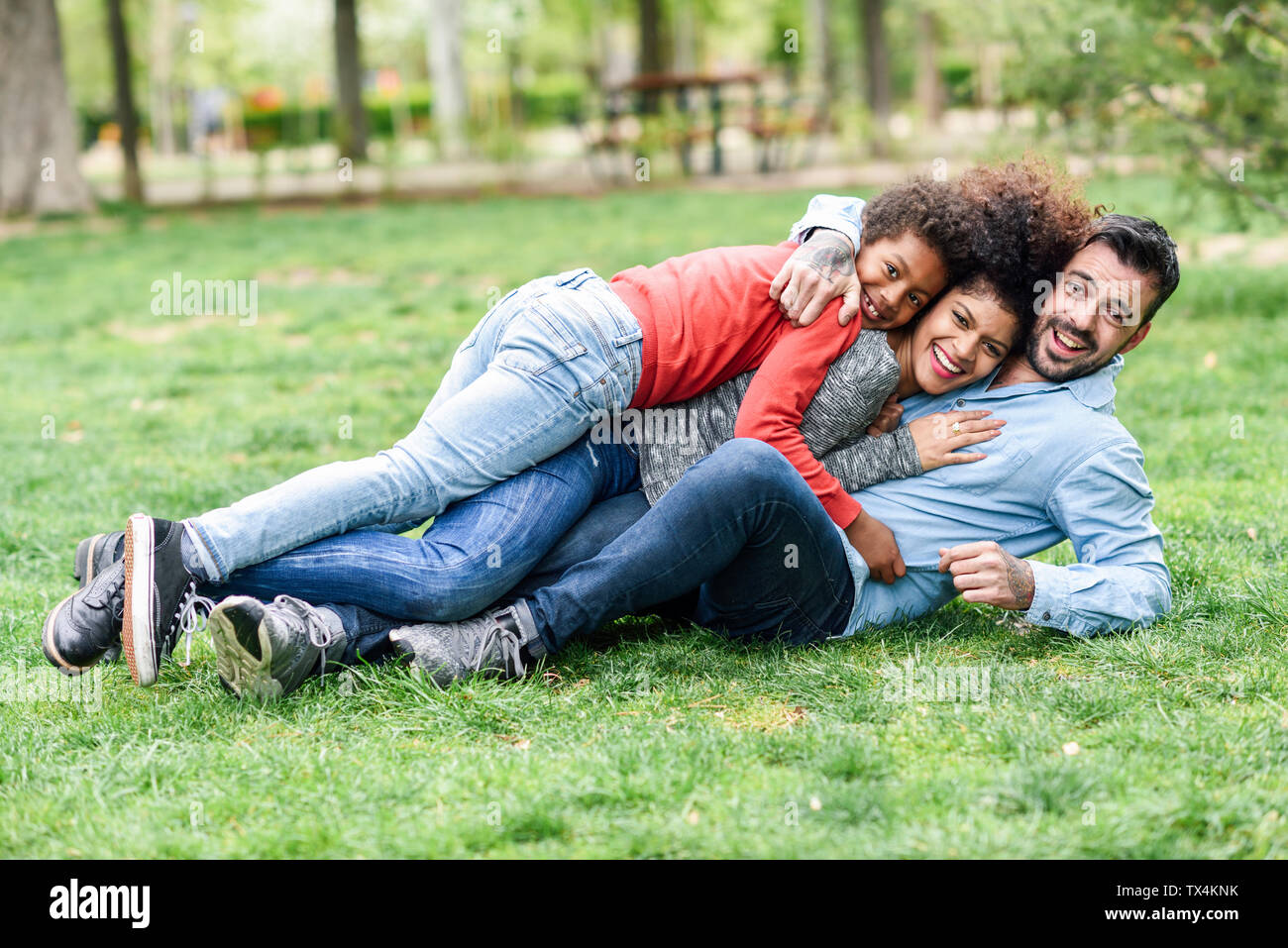 Happy children lying in grass hi-res stock photography and images - Alamy