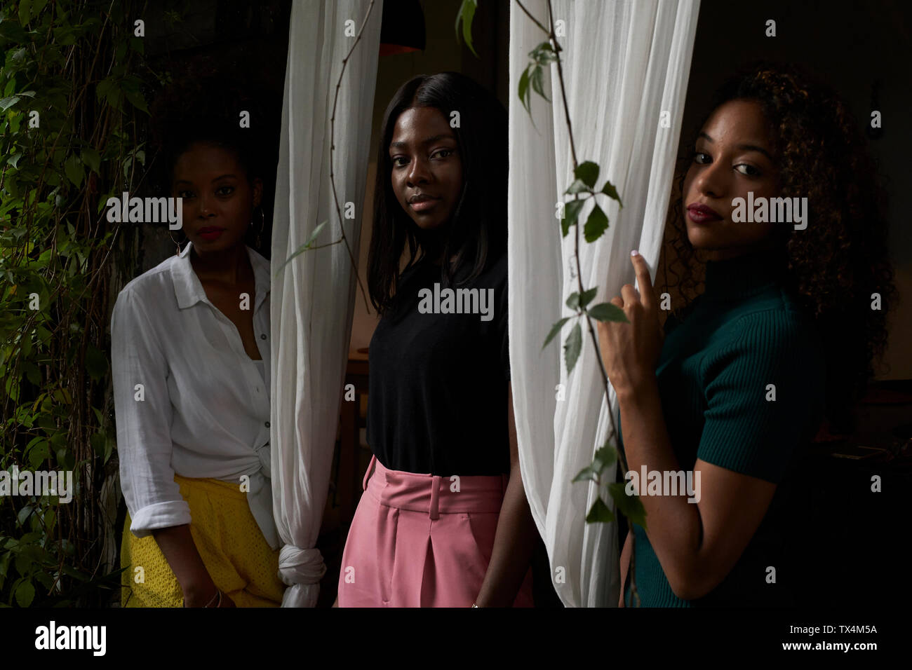 Portrait of three women standing between curtains Stock Photo - Alamy