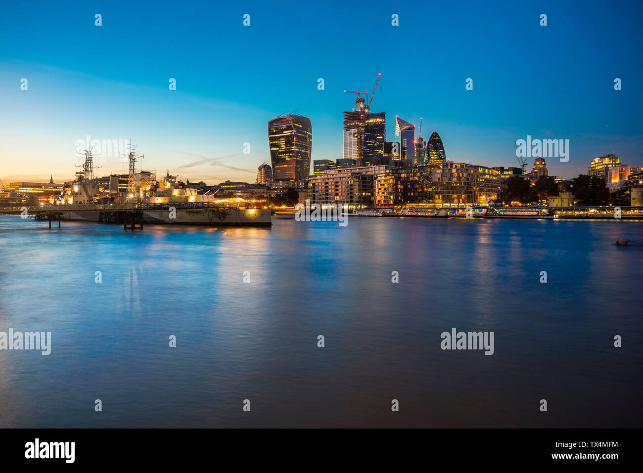 UK, London, Skyline at night with Hms Belfast in the foreground Stock Photo