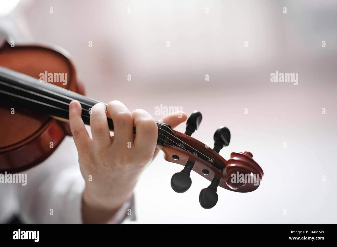 Close-up of girl playing violin Stock Photo