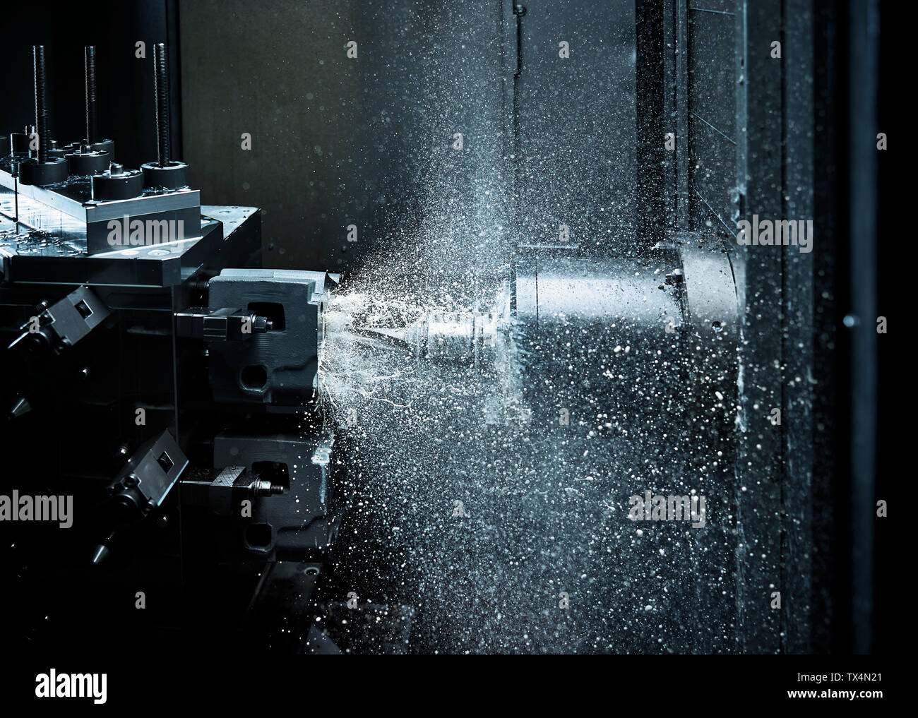 CNC machine drilling with coolant Stock Photo