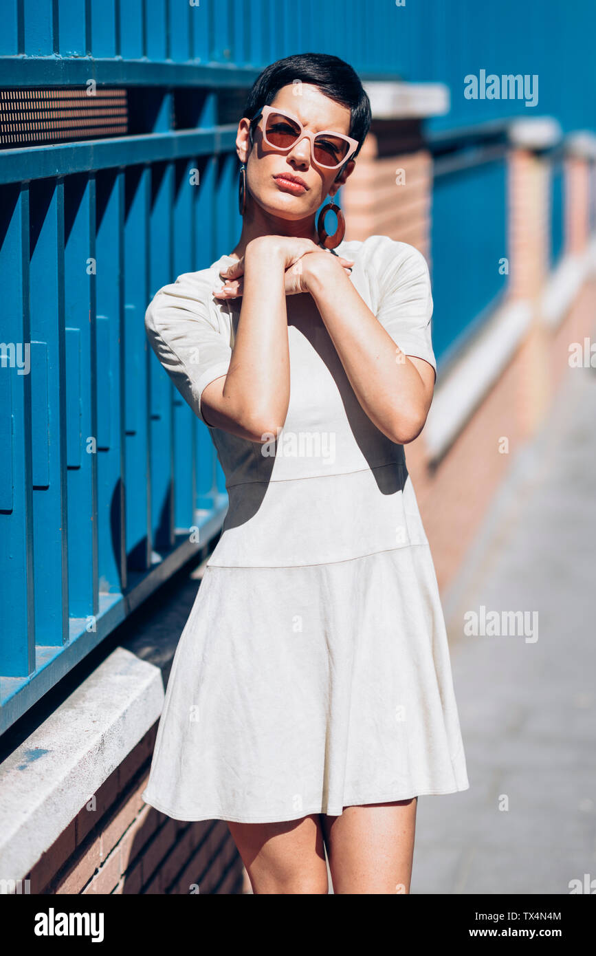 Fashionable young woman wearing dress and sunglasses Stock Photo