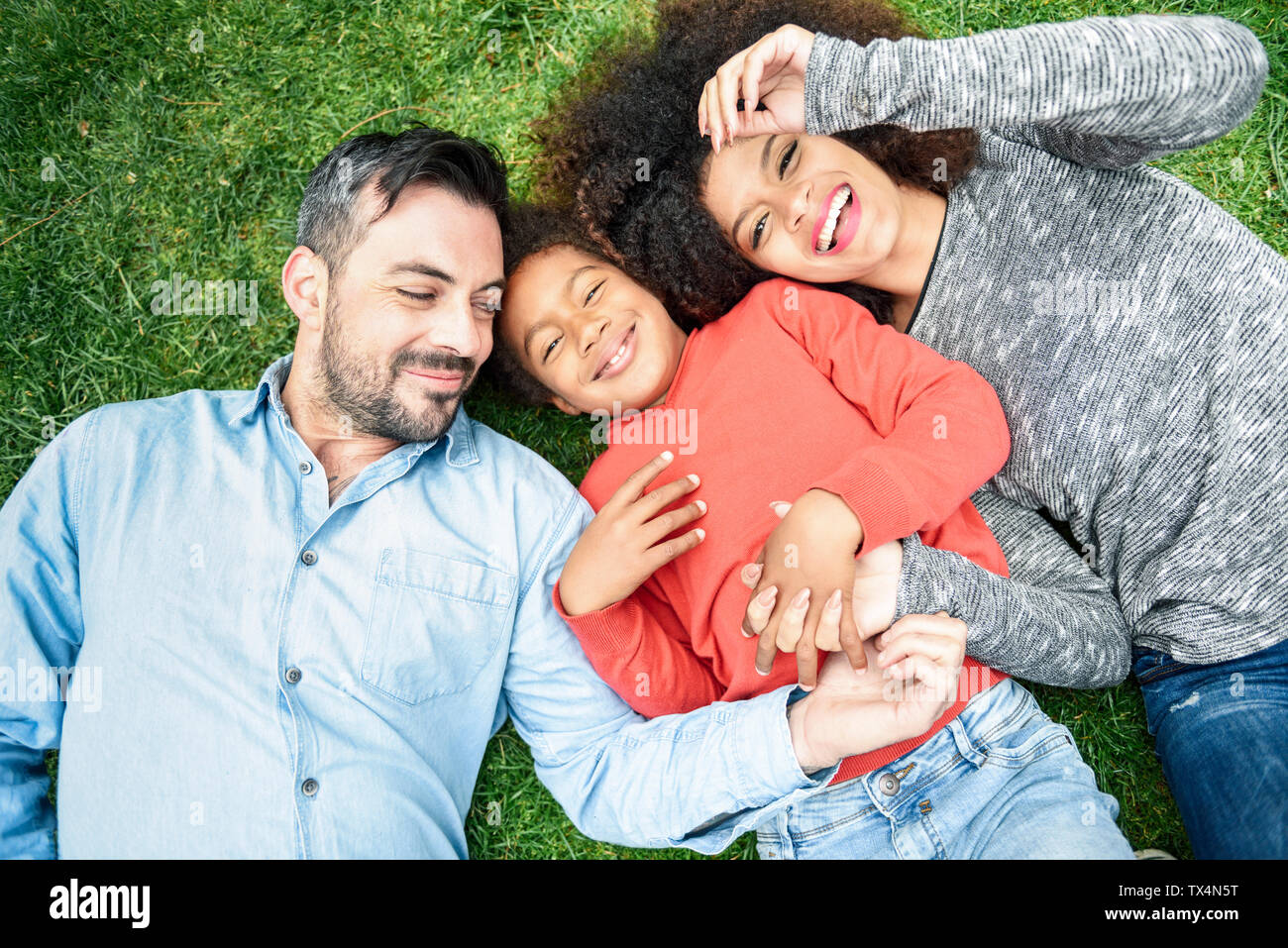 Happy children lying in grass hi-res stock photography and images - Alamy