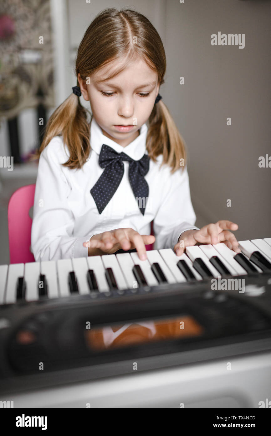 Portrait of focused a girl playing synthesizer Stock Photo