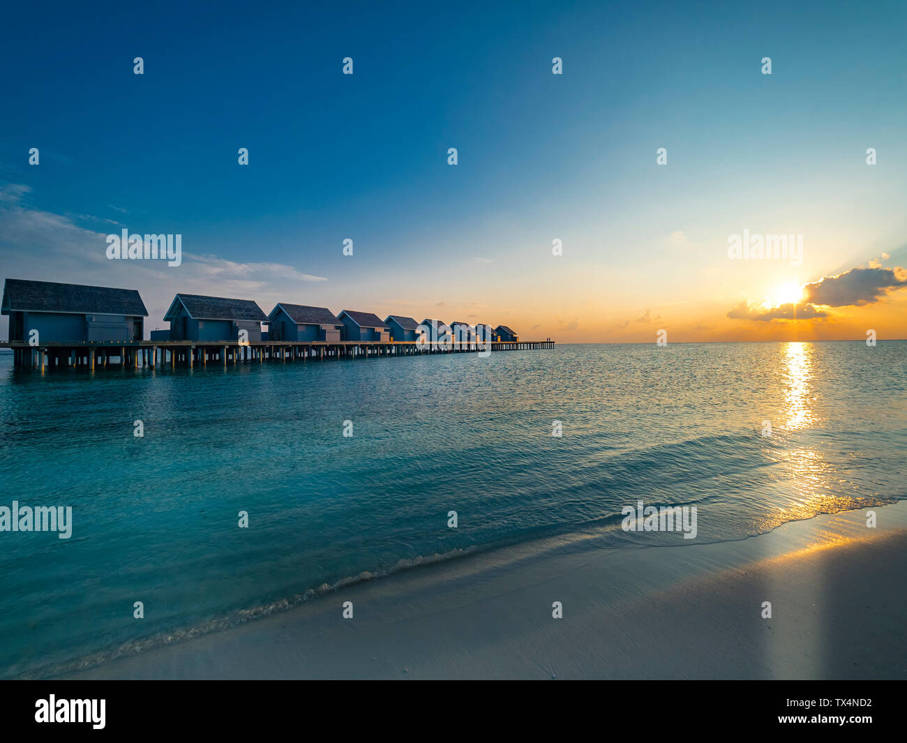Maledives, Ross Atoll, water bungalows at sunset Stock Photo