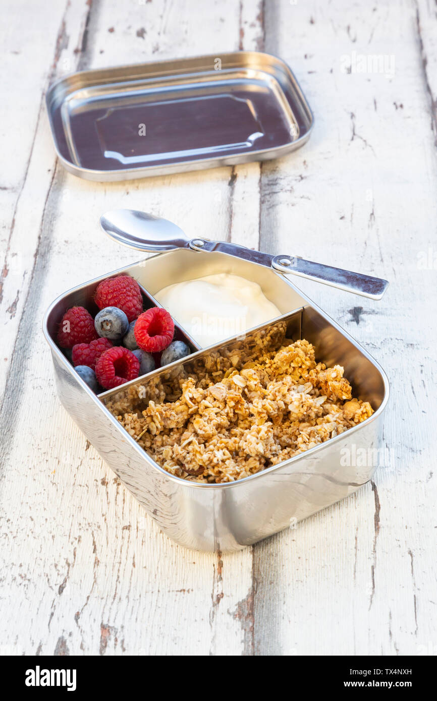Box with granola, greek yogurt, blueberries and raspberries Stock Photo