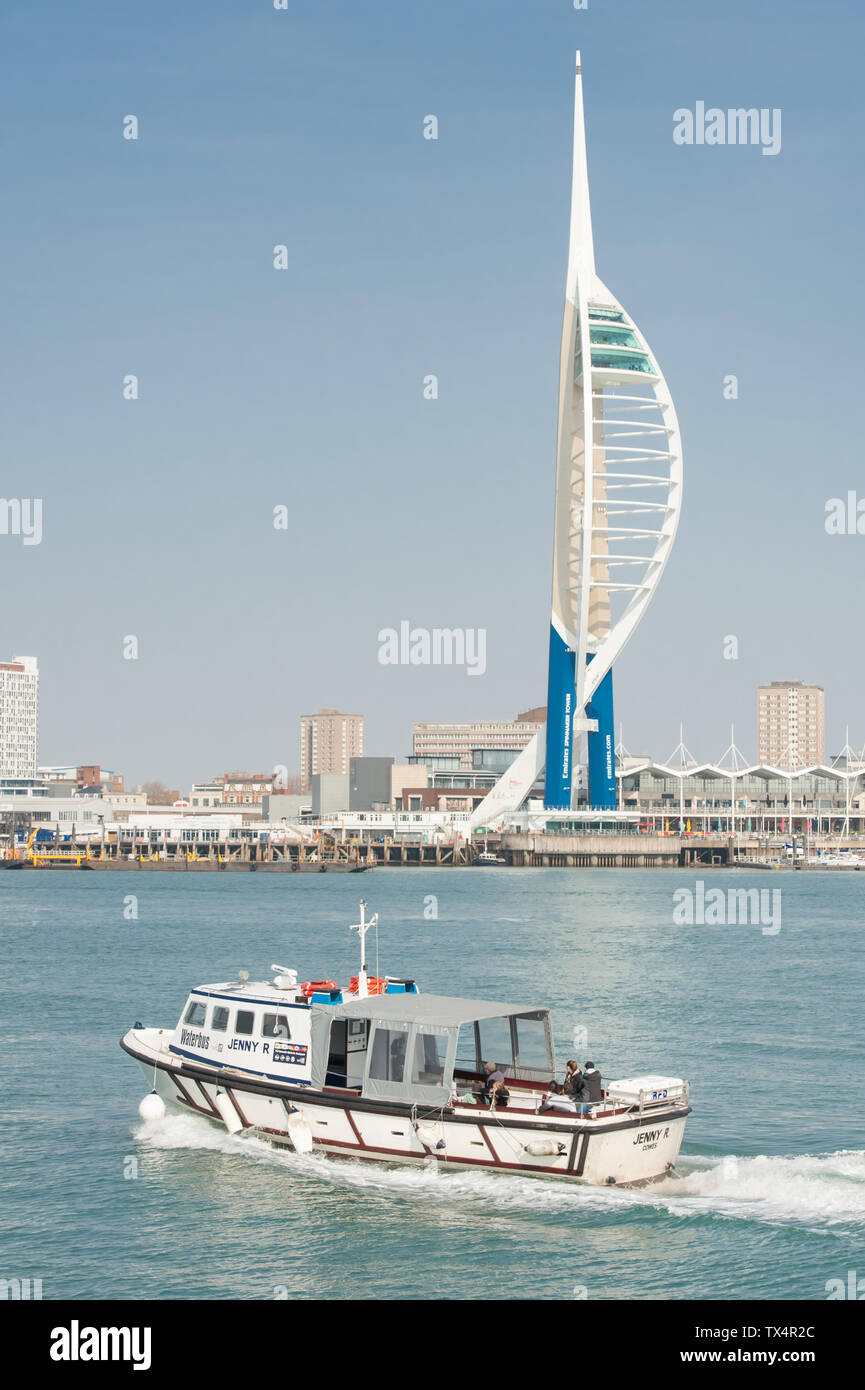 Portsmouth, UK - April 1, 2019: Spinnaker Tower landmark observation platform and waterbus in the historic naval dockyard port of Portsmouth, UK Stock Photo
