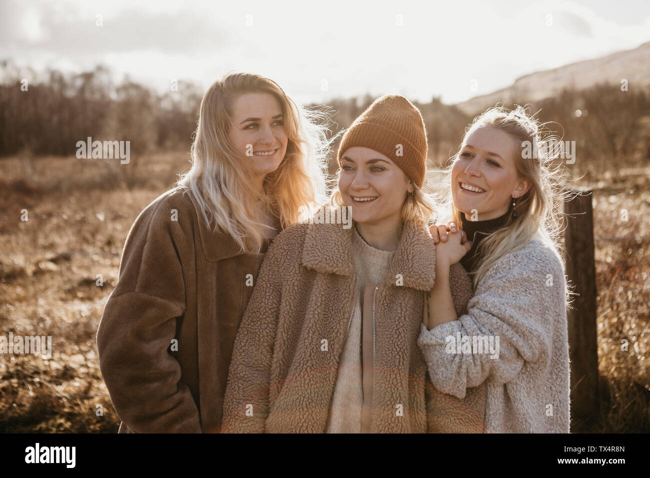 UK, Scotland, happy female friends in rural landscape Stock Photo
