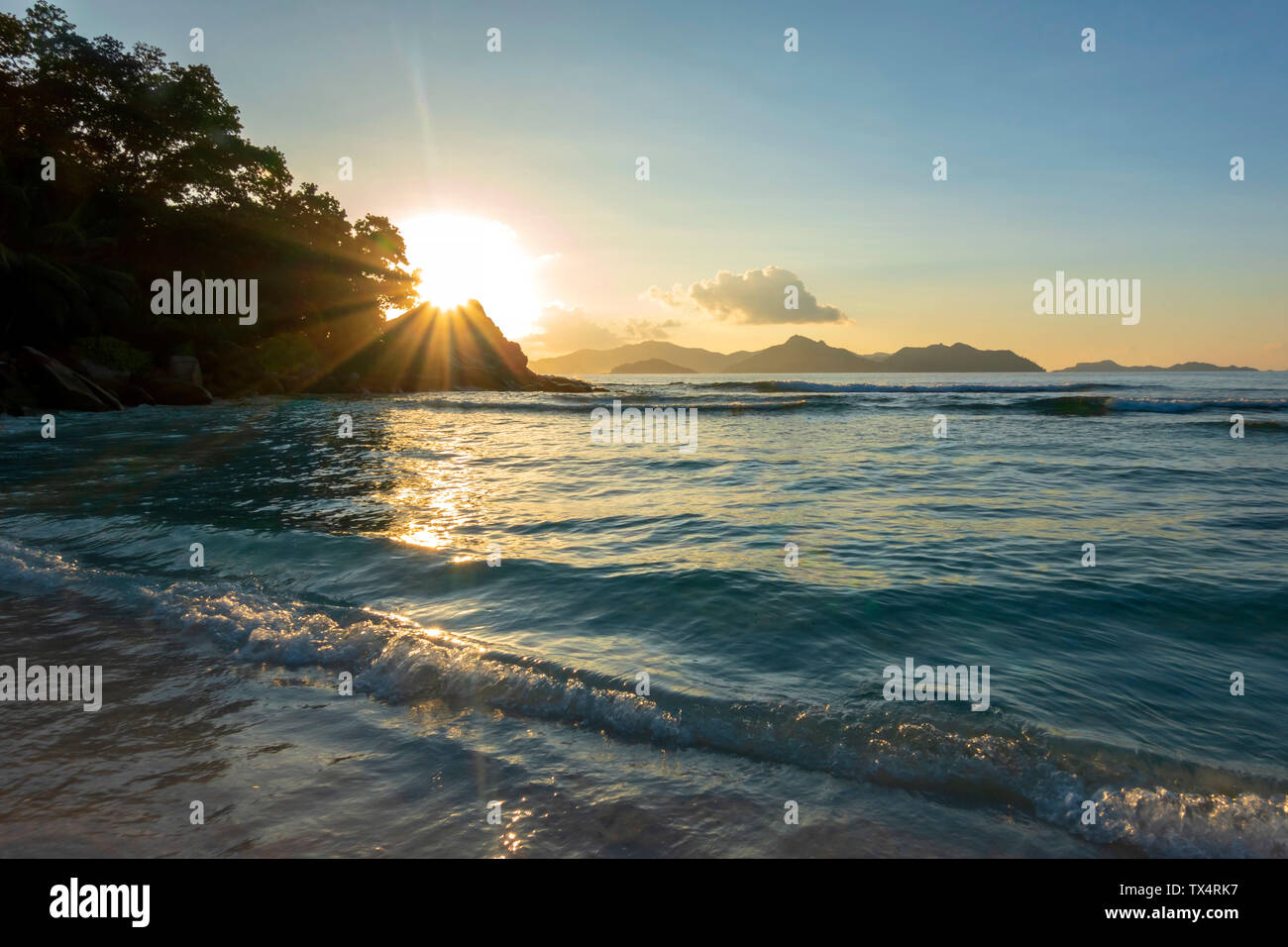 Seychelles, Mahe, view to the sea from Takamaka Beach at sunset Stock Photo