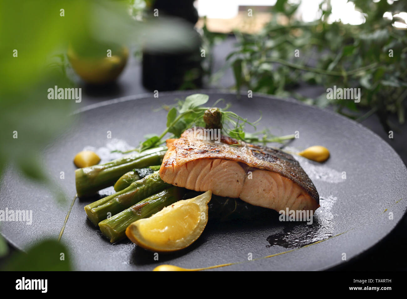Grilled salmon on green asparagus. An elegant exquisite dish. Stock Photo