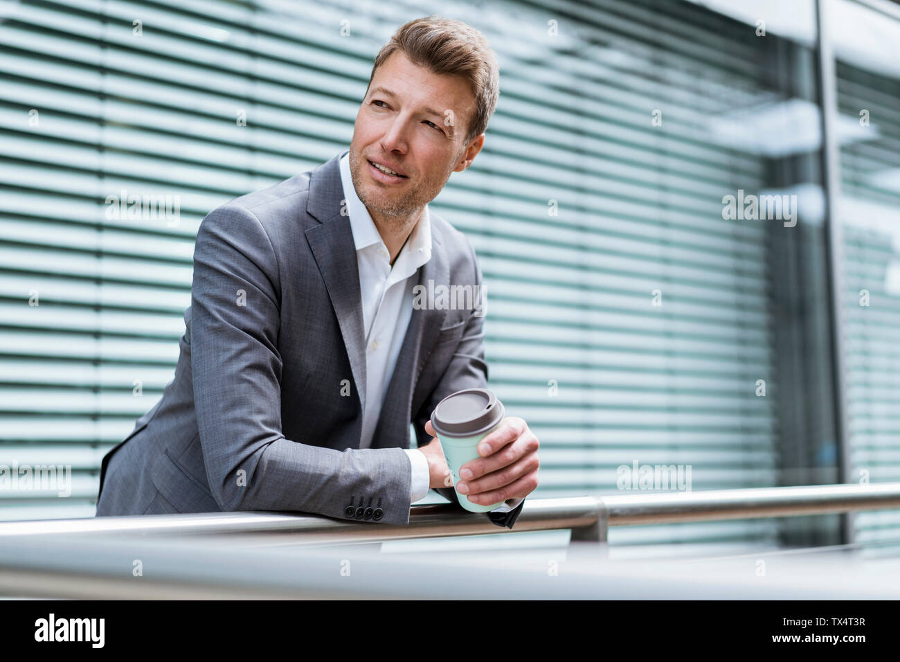 Businessman with takeaway coffee outside in the city Stock Photo