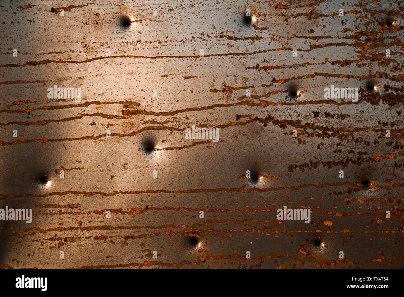Rusty abstract metal background with looks like bullet holes Stock Photo