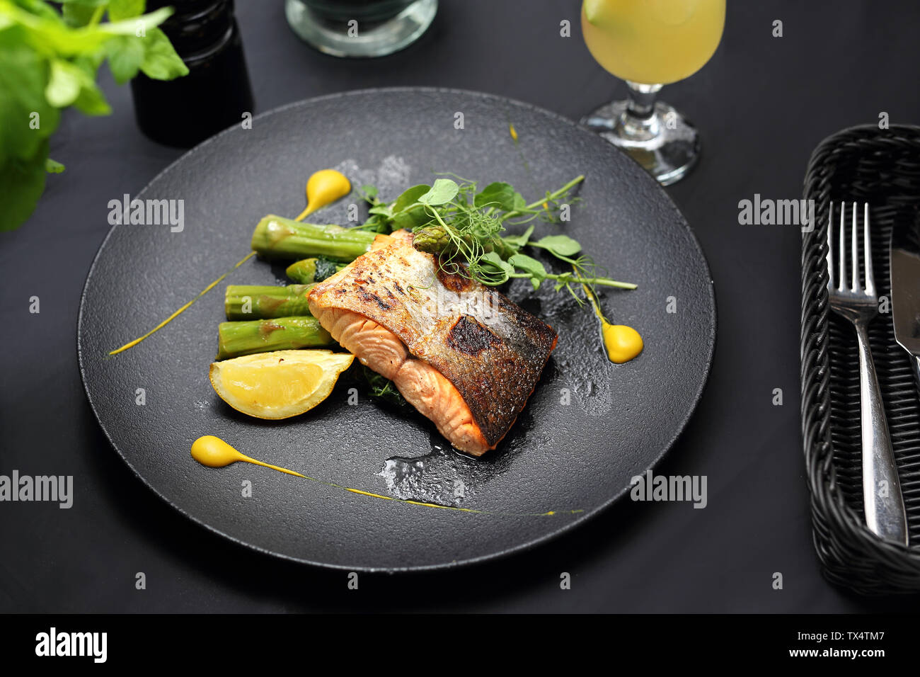 Grilled salmon on green asparagus. An elegant exquisite dish. Stock Photo
