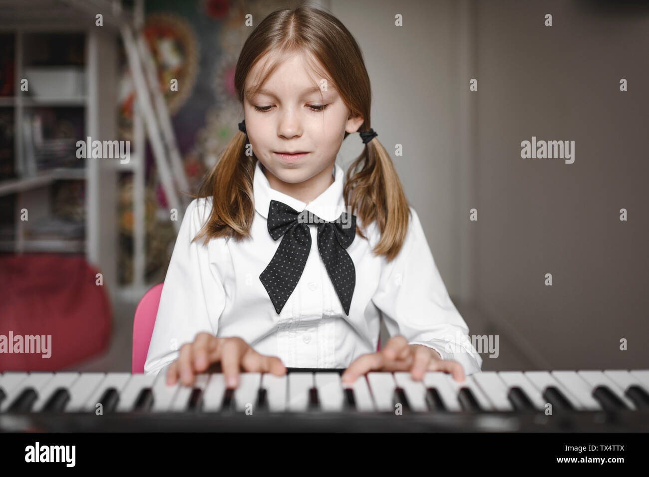 Portrait of a girl playing synthesizer Stock Photo