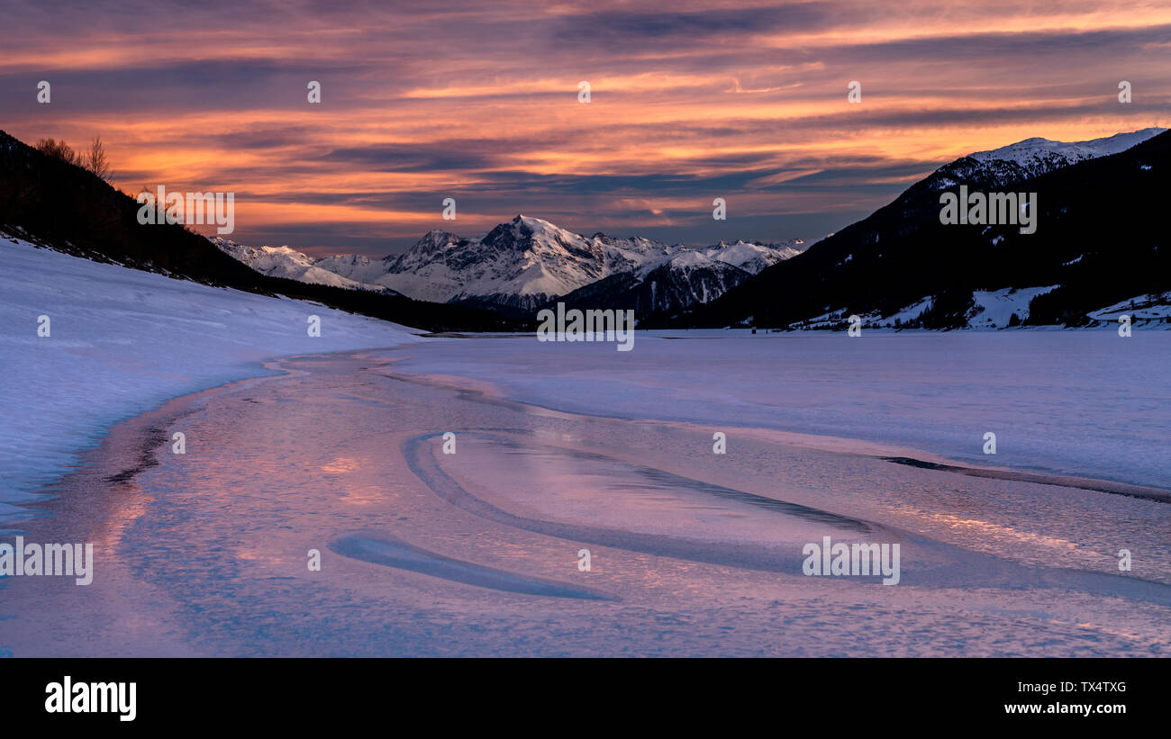 Italy, Venosta Valley, Lago di Resia in winter at sunset Stock Photo