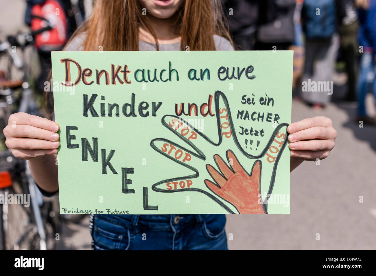 Girl holding a placard on a demonstration for environmentalism Stock Photo
