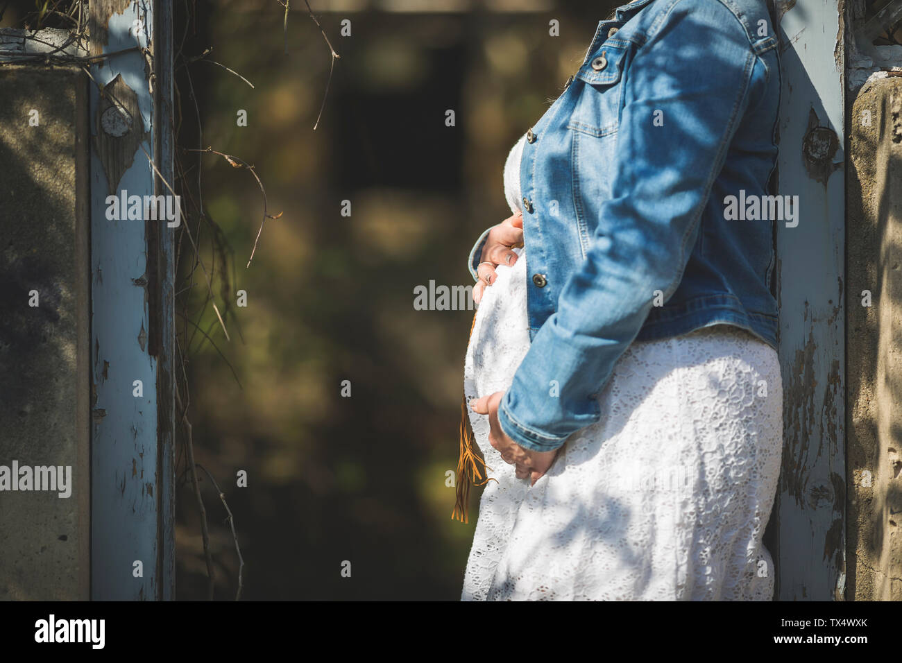 Pregnant woman holding her belly, close up Stock Photo