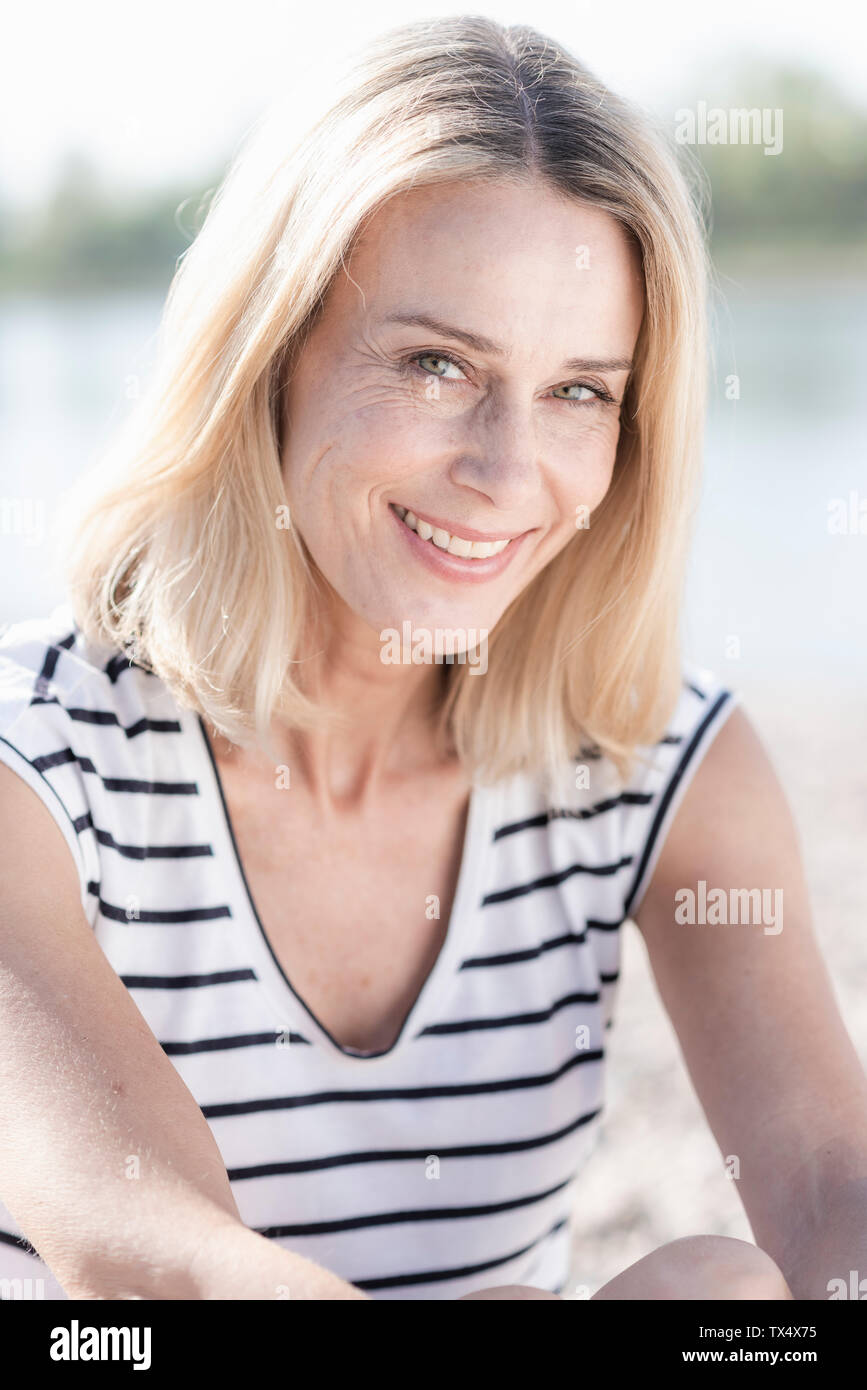 Portrait of smiling mature woman outdoors Stock Photo - Alamy