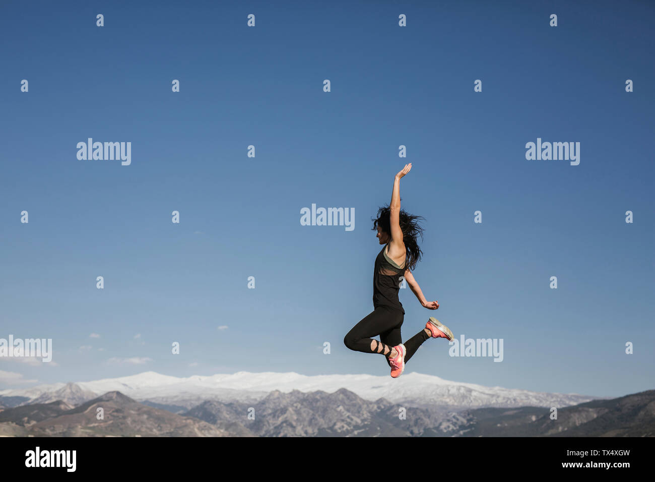 Woman jumping joy in mountain hi-res stock photography and images - Alamy