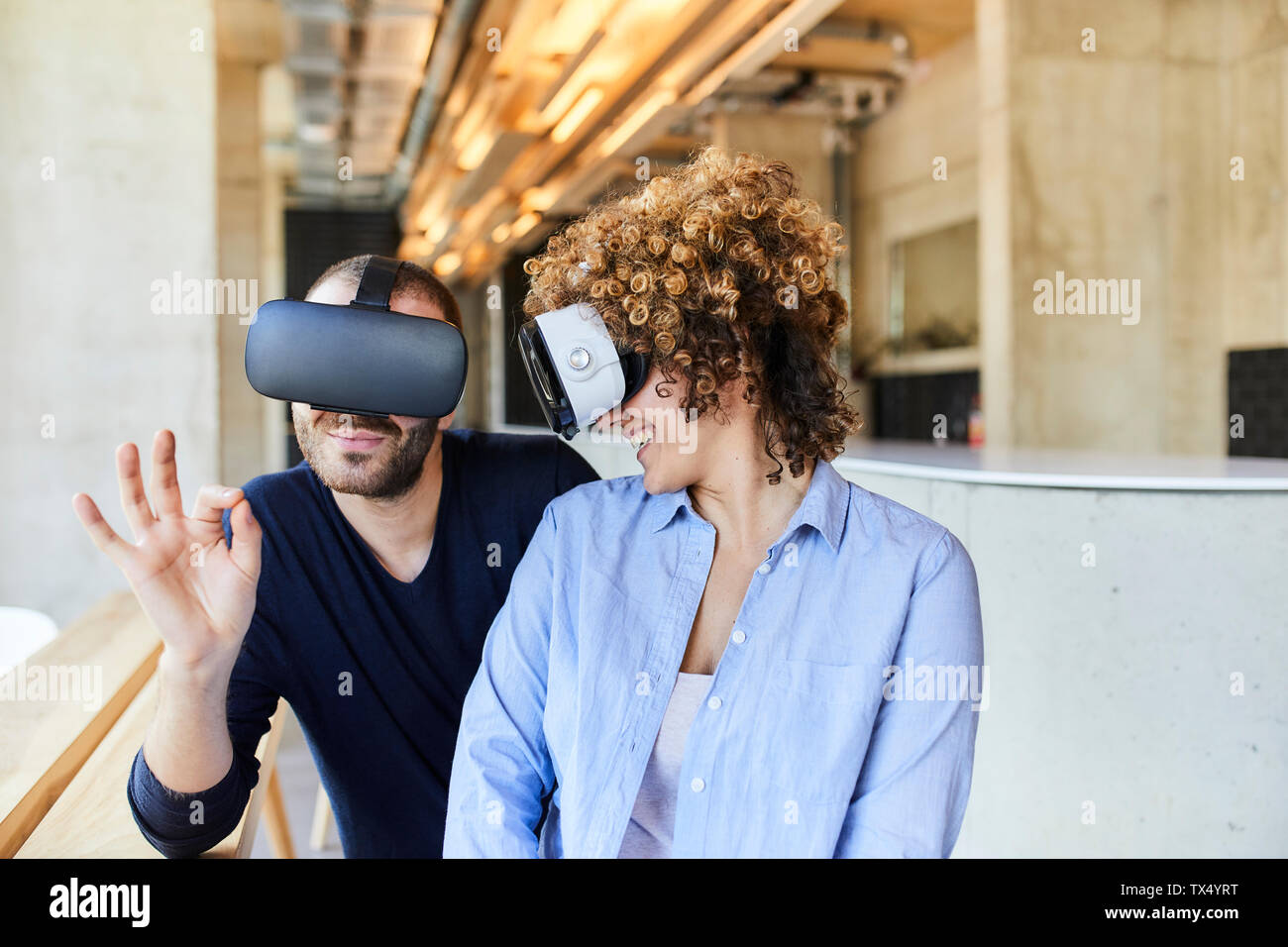 Man and woman wearing VR glasses in modern office Stock Photo