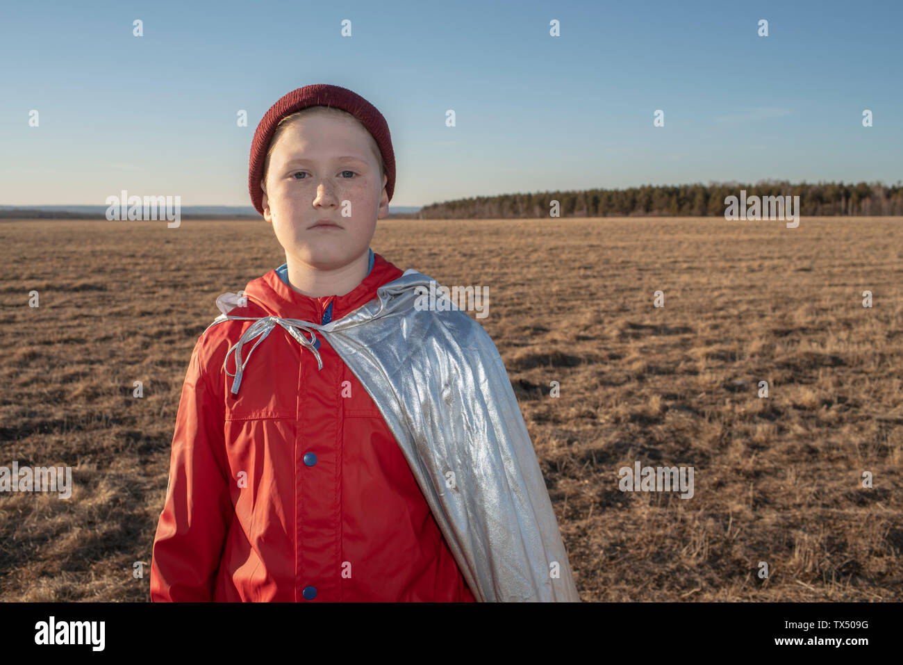 Portrait of boy dressed up as superhero in steppe landscape Stock Photo