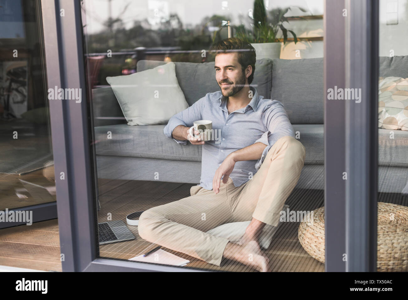 Free Stock Photo of Young Man sitting near window