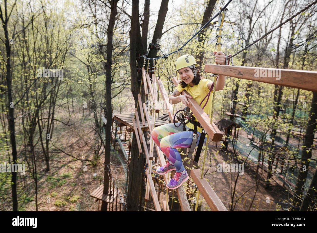 Young woman in a rope course Stock Photo