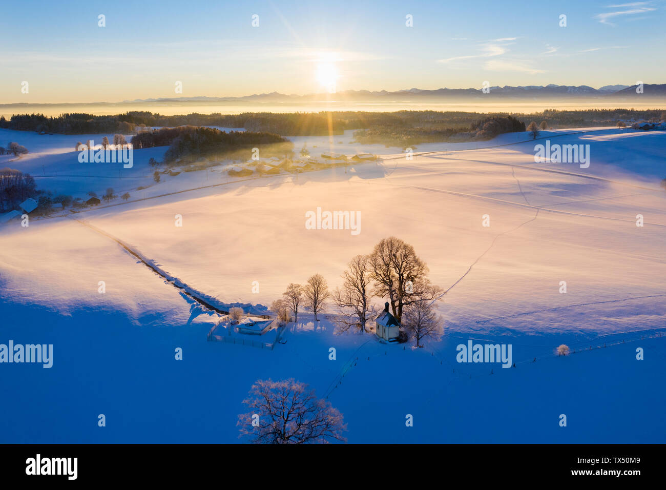 Germany, Bavaria, Degerndorf, winter landscape with Maria Dank chapel on Fuerst Tegernberg at sunrise, aerial view Stock Photo