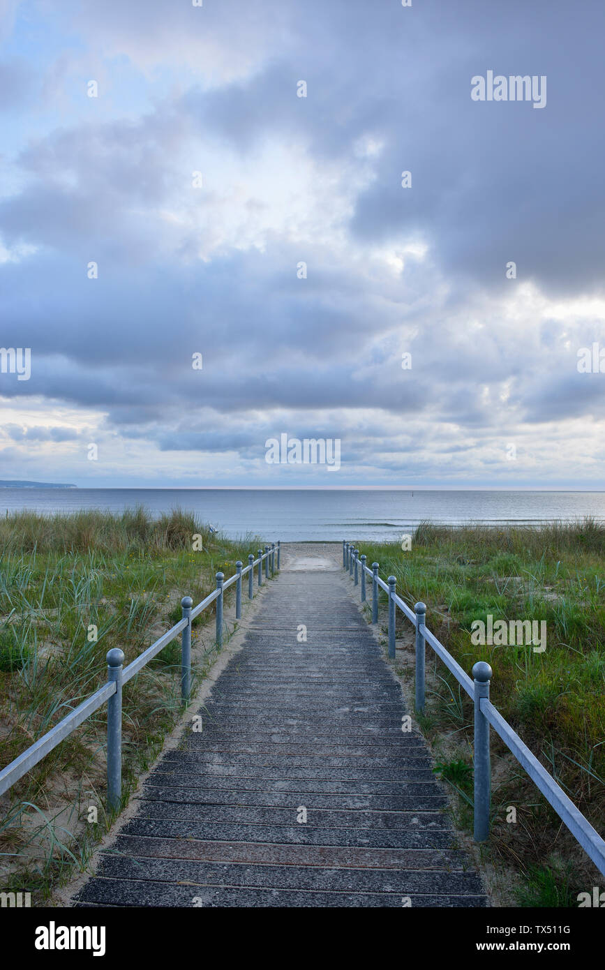 Germany, Ruegen Island, Binz, Baltic Sea, wooden boardwalk to beach in the evening Stock Photo