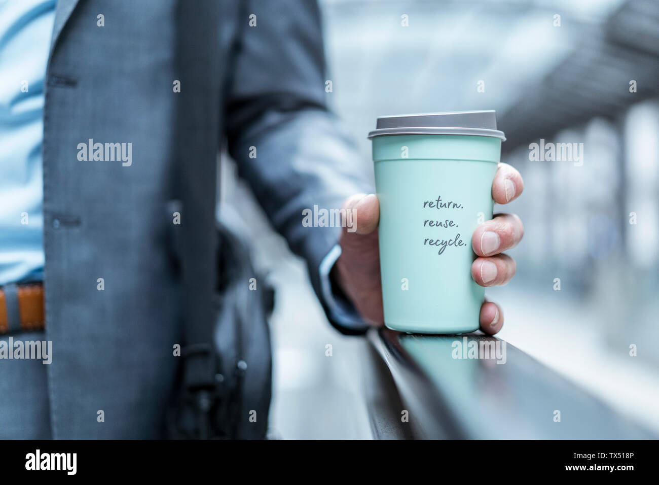 Close-up of businessman holding recycable takeaway coffee cup Stock Photo