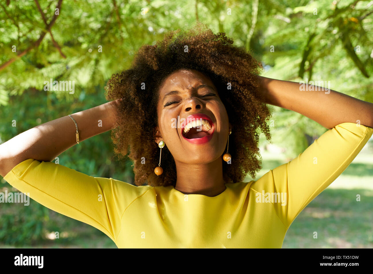 Portrait of young woman screaming for joy Stock Photo