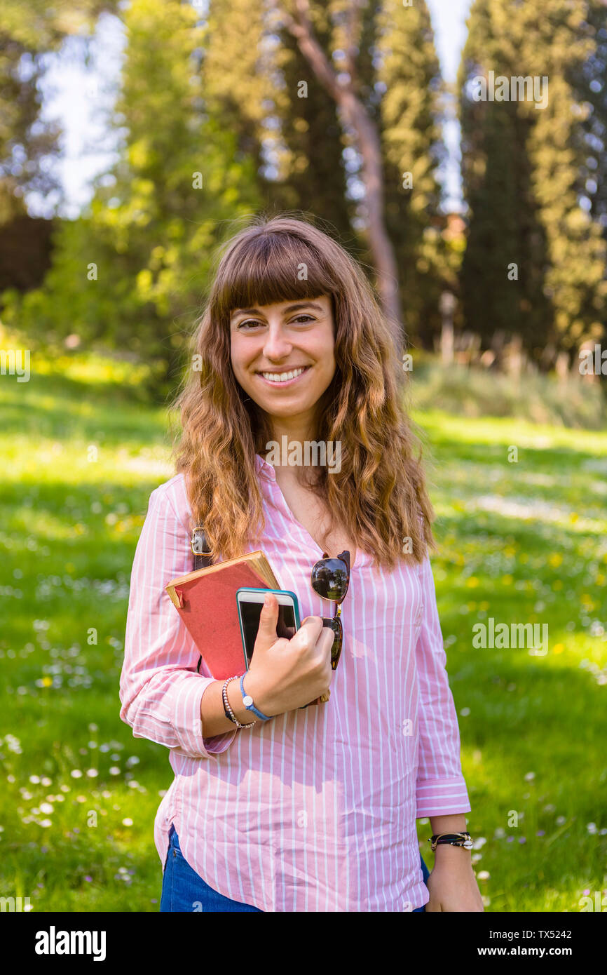 Young woman on a city break, holding guidebook Stock Photo