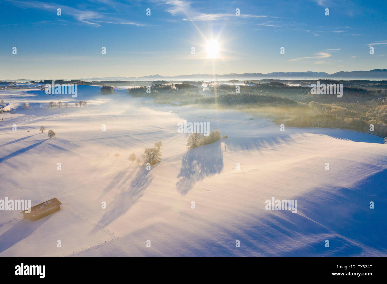 Germany, Bavaria, near Muensing, winter landscape with alps at sunrise, aerial view Stock Photo